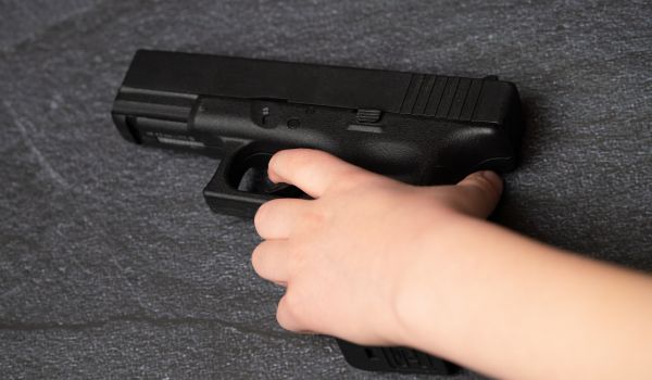 Person grabbing hand gun